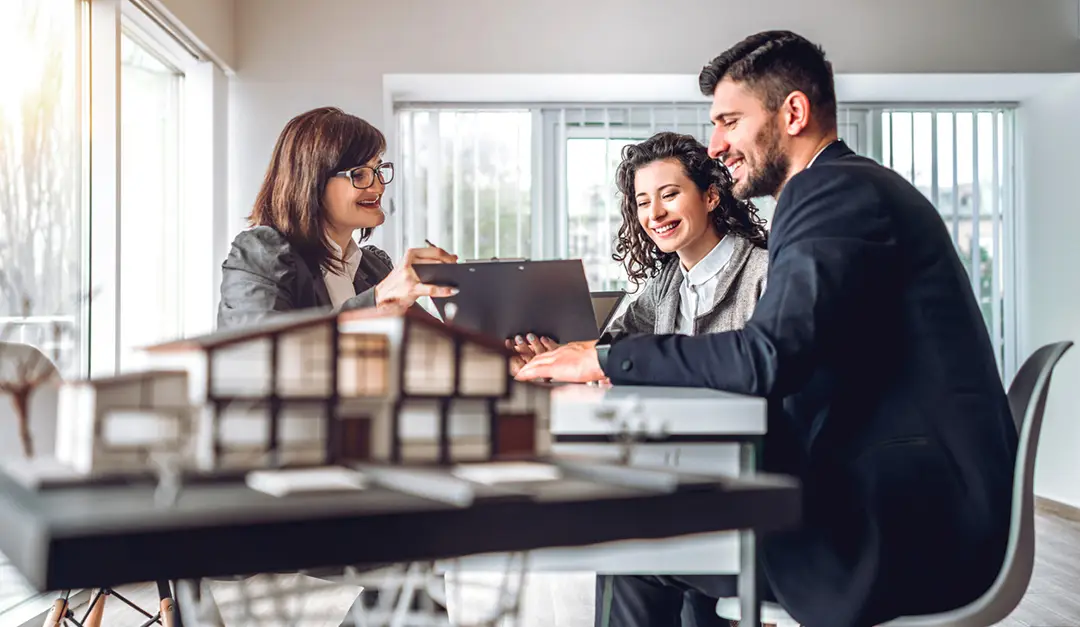 side view image of young happy family sitting in consulting office, making property purchase. mature female realtor helping business couple do financial investment. installment payment, mortgage, loan for estate concept